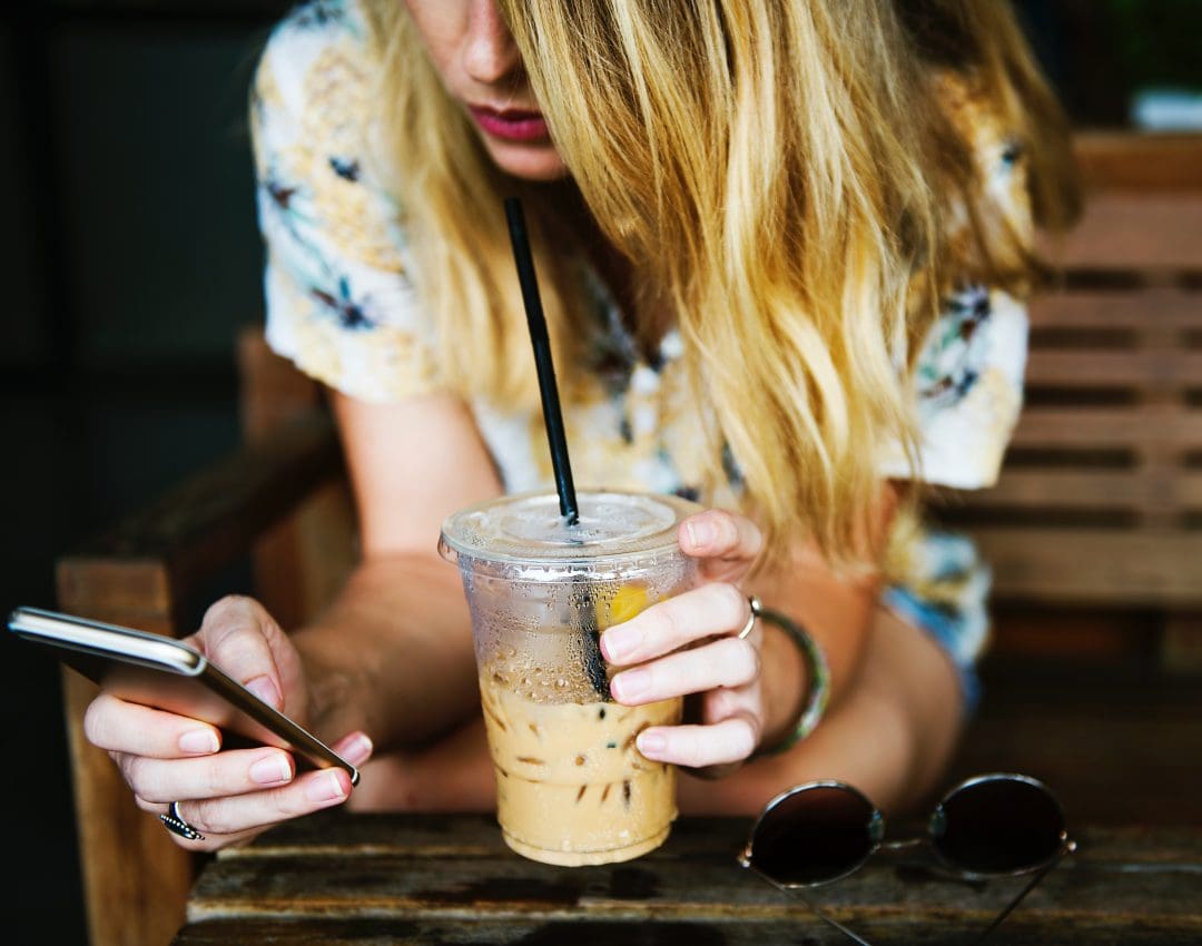 Woman Drinking Coffee on Phone