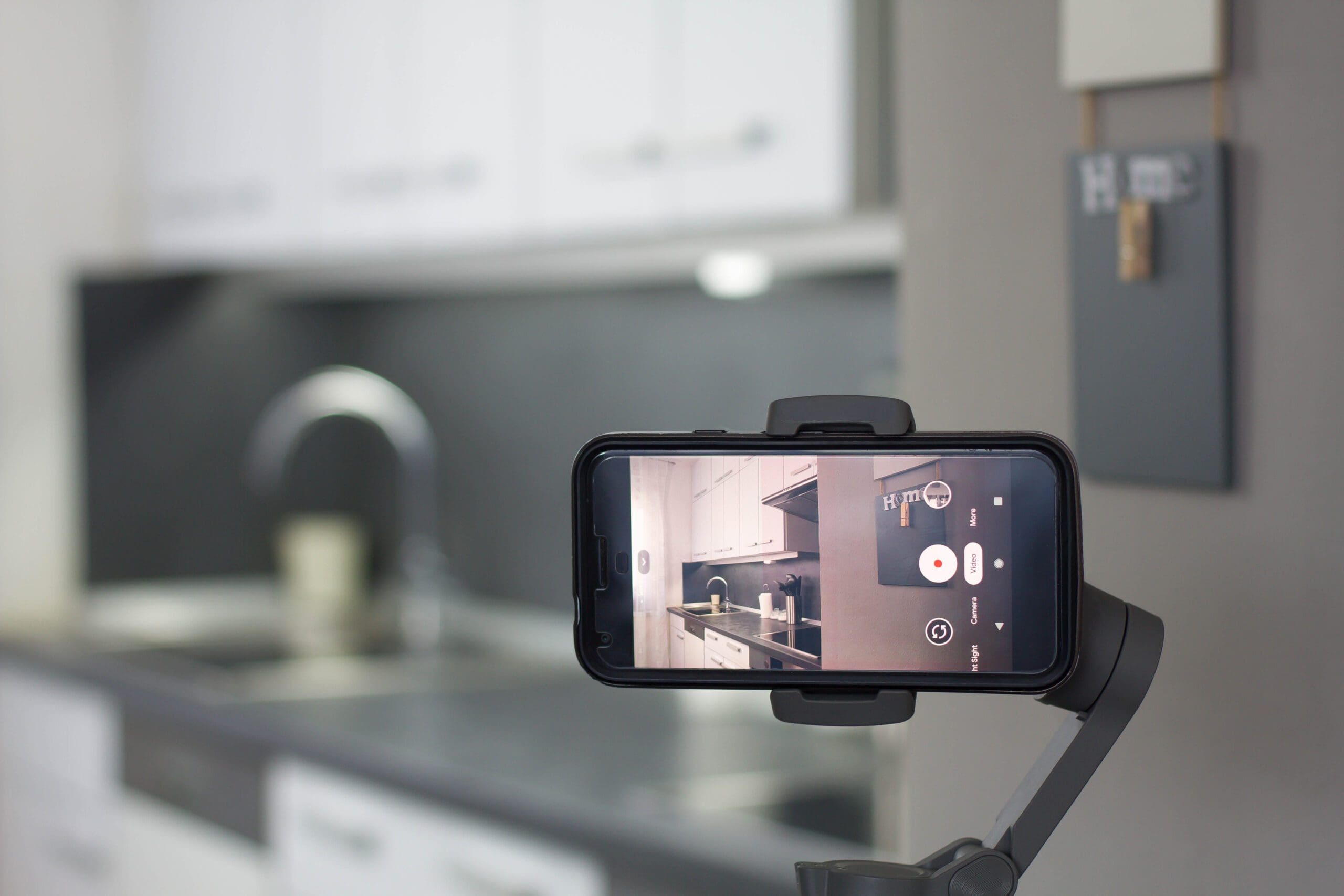 Mobile phone recording a home video on a gimbal stabilizer.